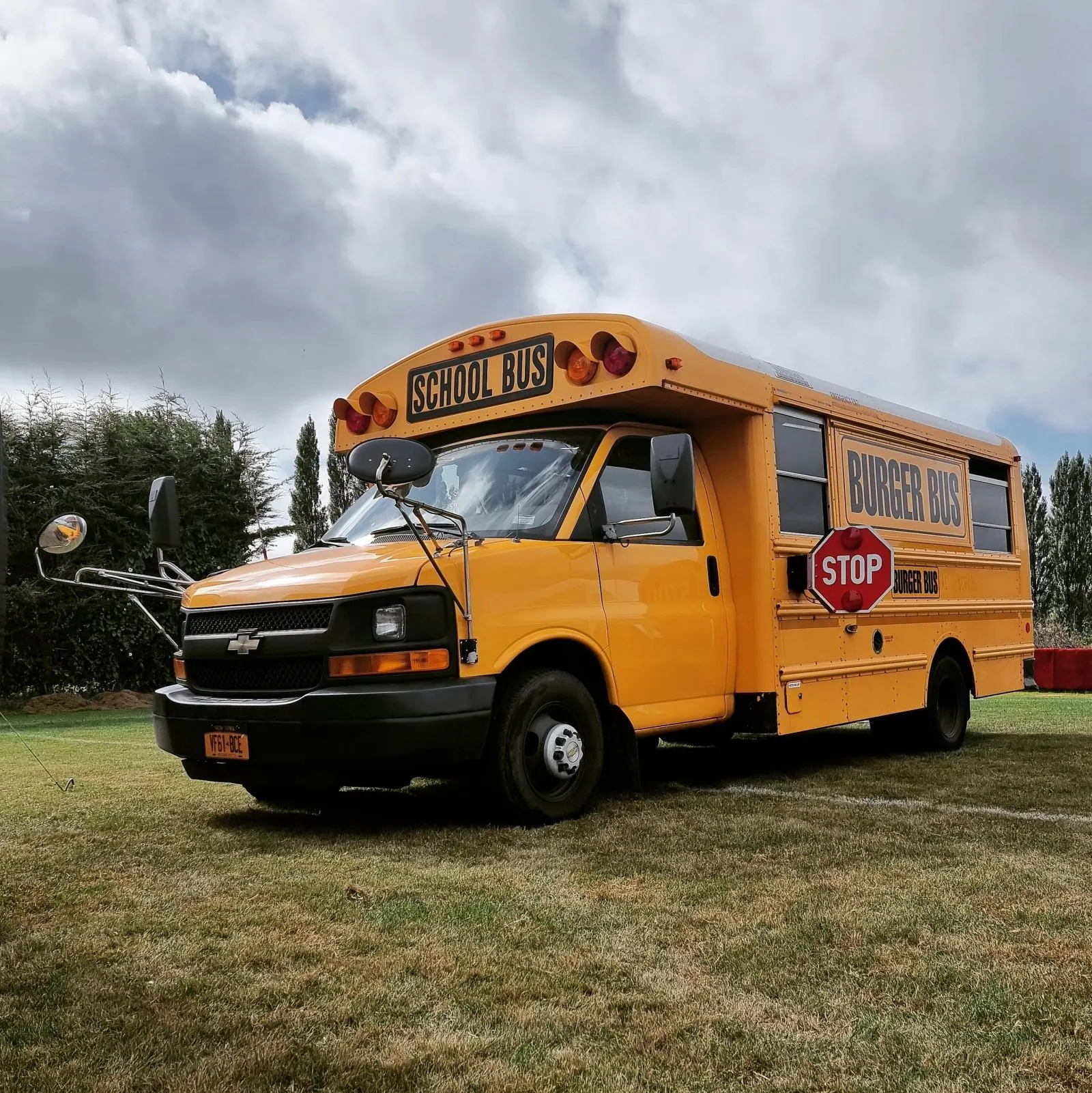 Burger Bus parked on grass at an event