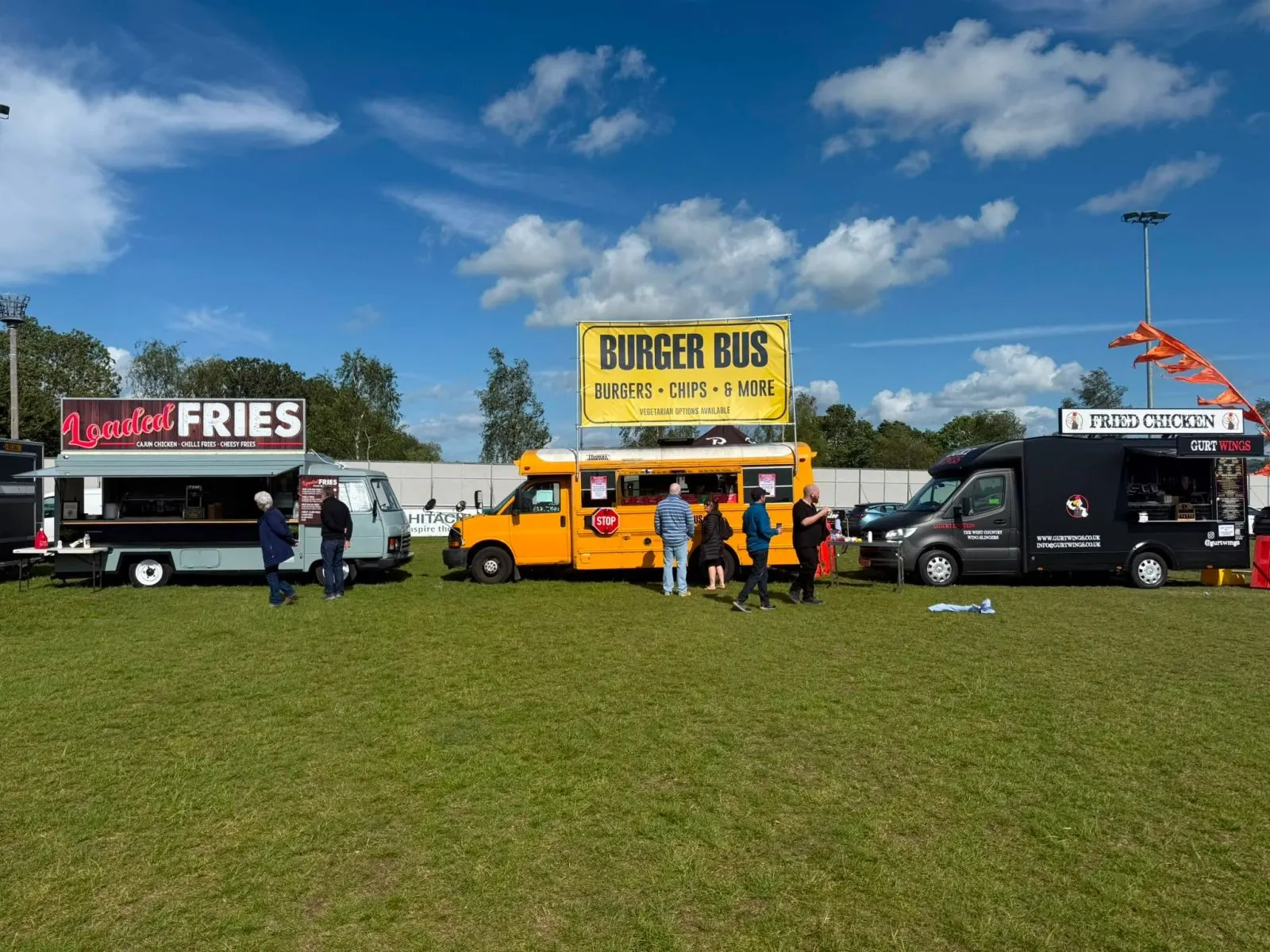 Burger Bus between other food trucks in a festival field
