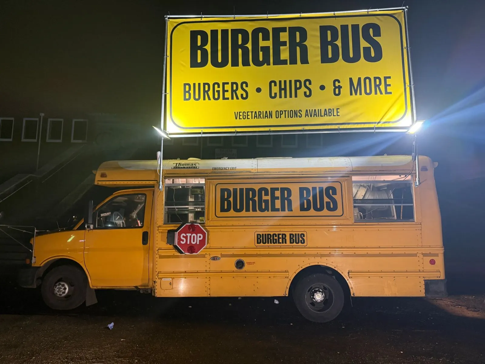 Burger Bus with its sign lit up at night