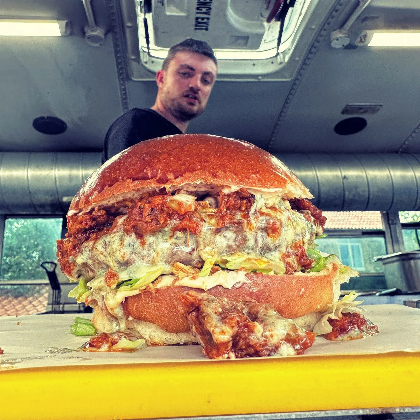 A giant burger being made inside the bus